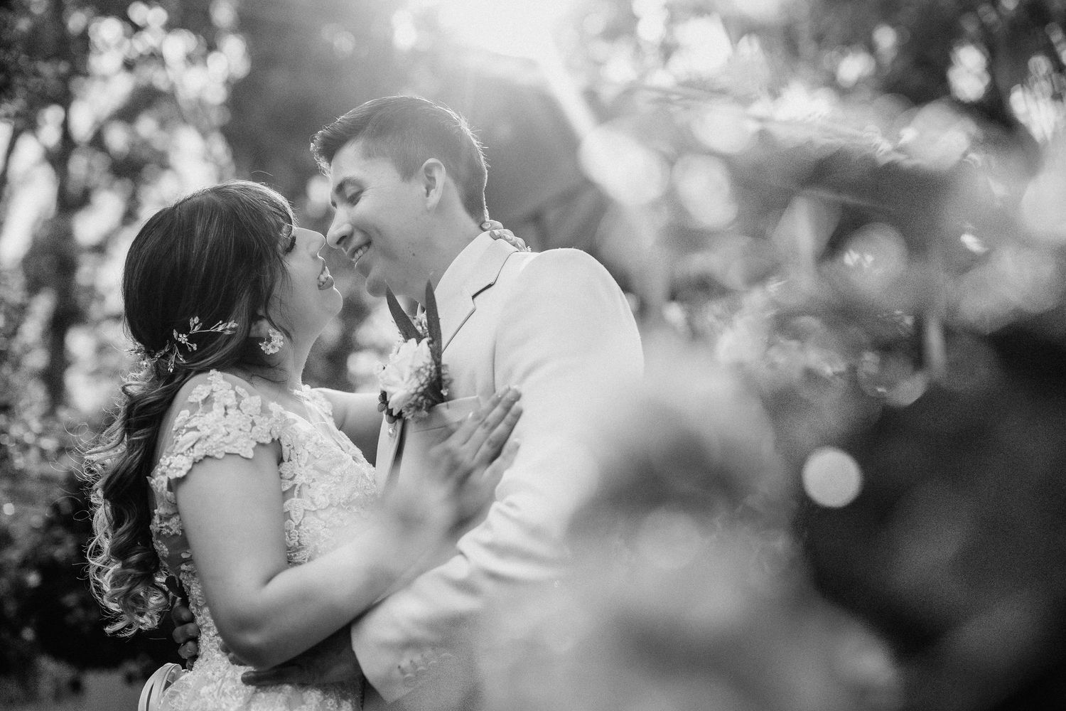 Black and white wedding photography series showing intimate moments between couples in romantic outdoor settings.
