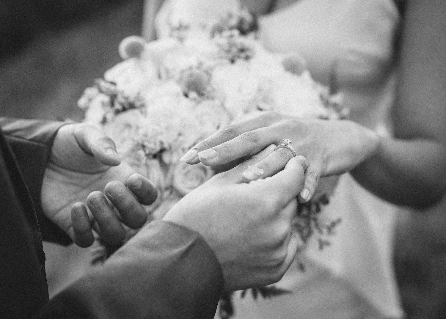 Black and white photo sequence showing hands exchanging a delicate bouquet of white flowers.