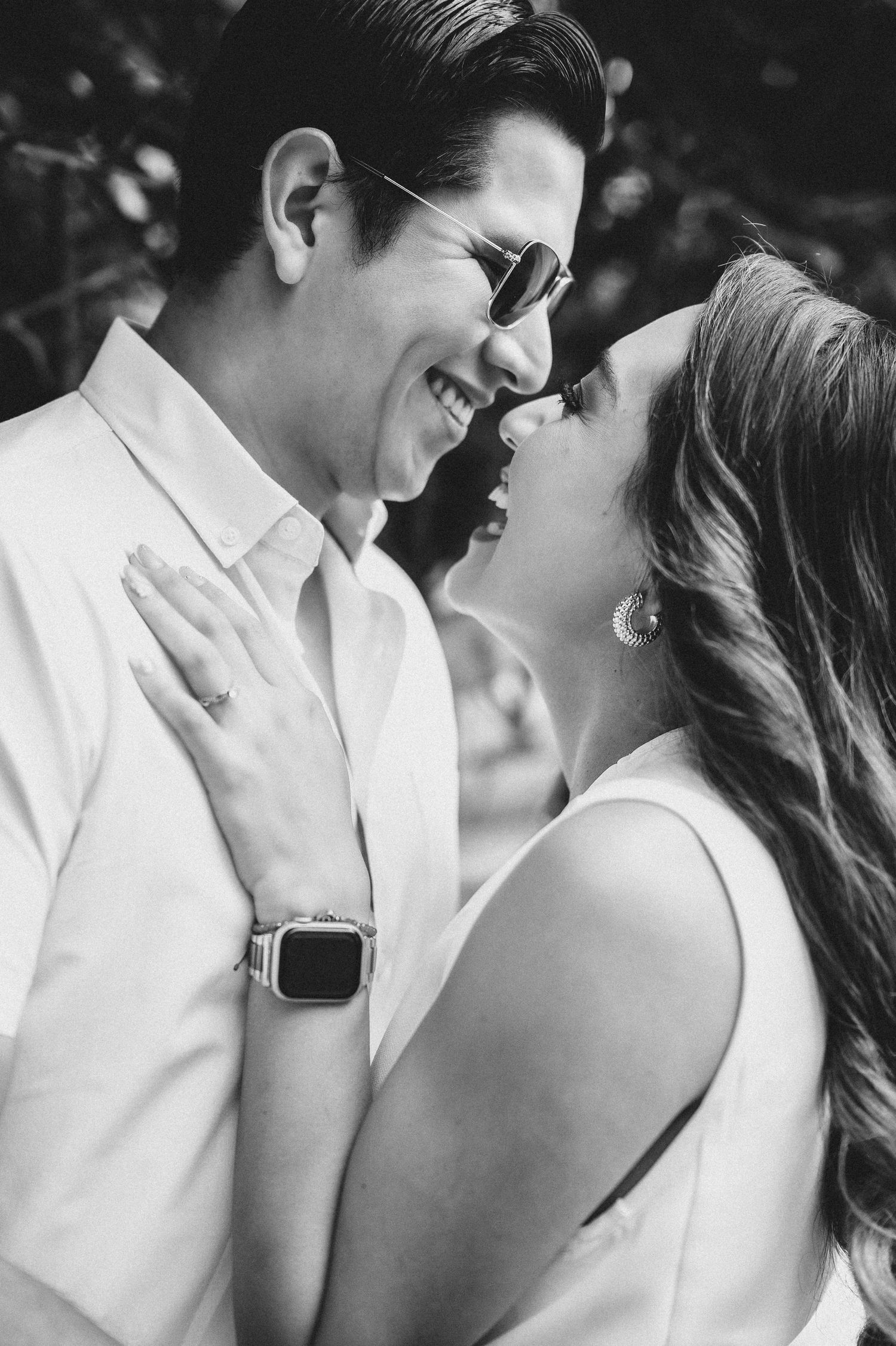 Black and white intimate portrait series showing a romantic couple in close embrace wearing white.