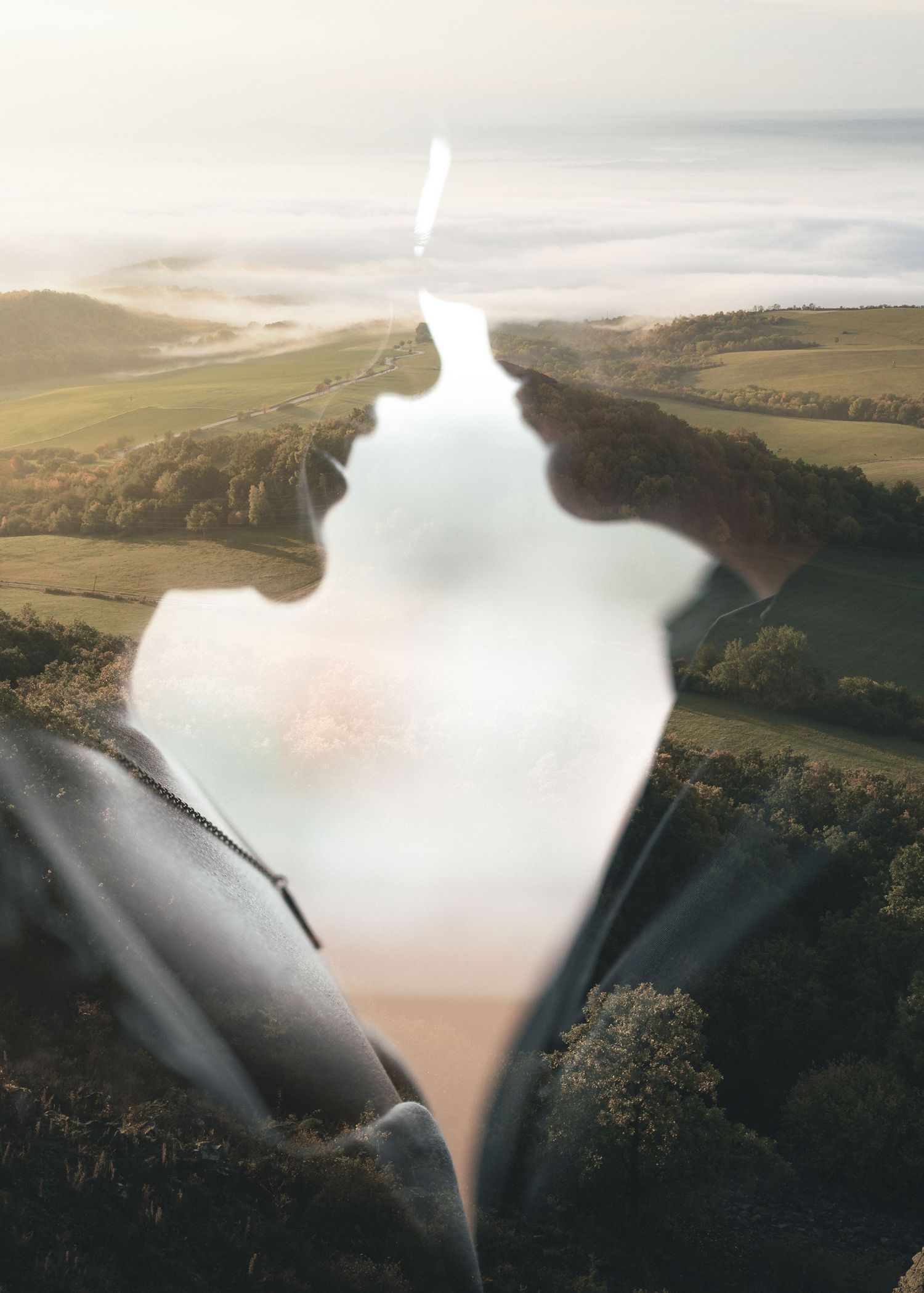 Aerial timelapse sequence showing water draining through a morning glory spillway at a reservoir creating a vortex effect.
