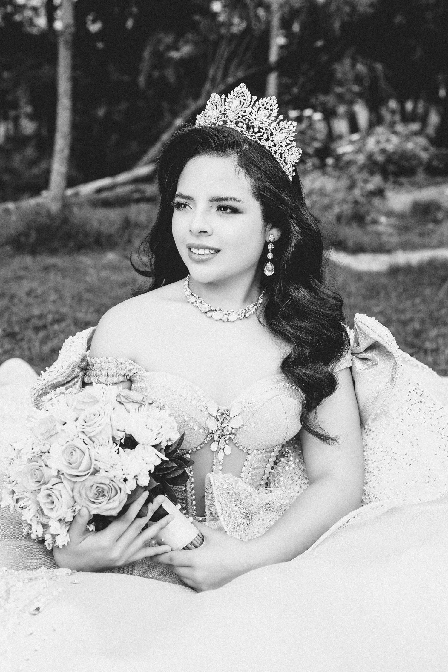 A glamorous bridal boudoir photoshoot in black and white featuring elegant lace and a tiara.