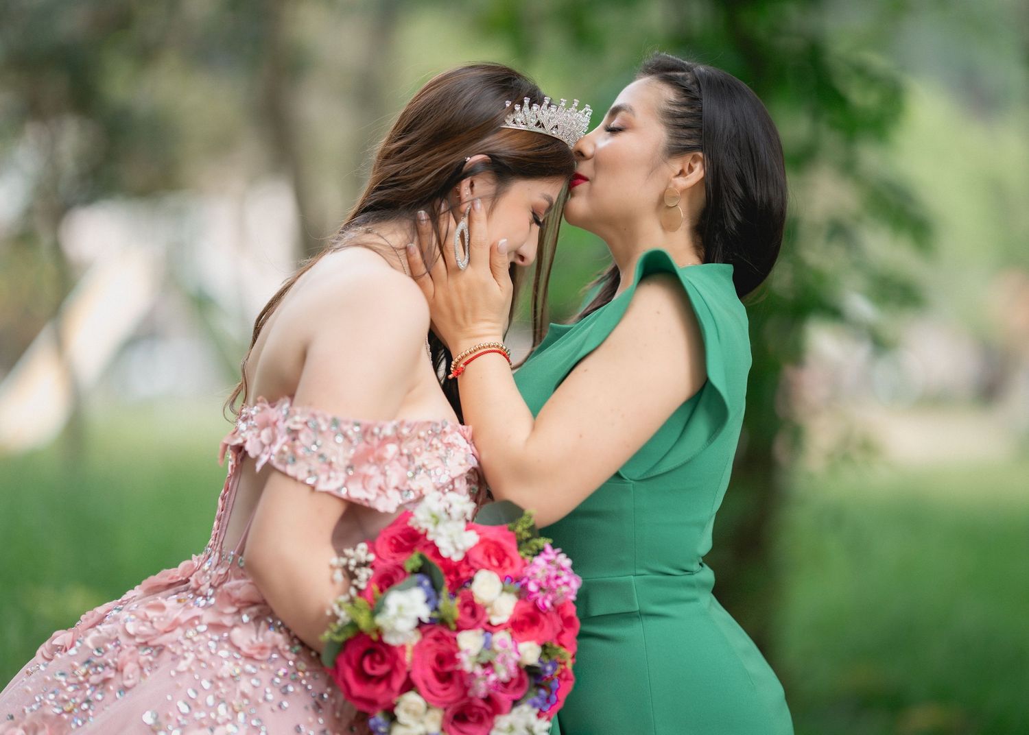 A romantic couple shares tender moments in a garden setting with pink roses and green foliage.