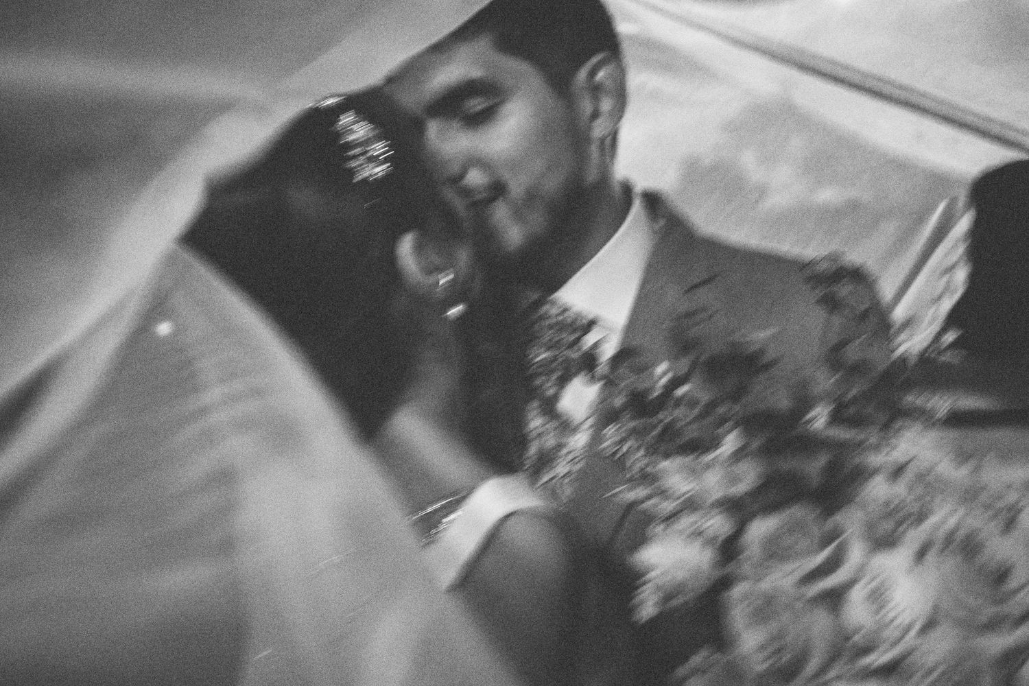 A black and white collage of wedding photos showing intimate moments between a couple during their celebration.