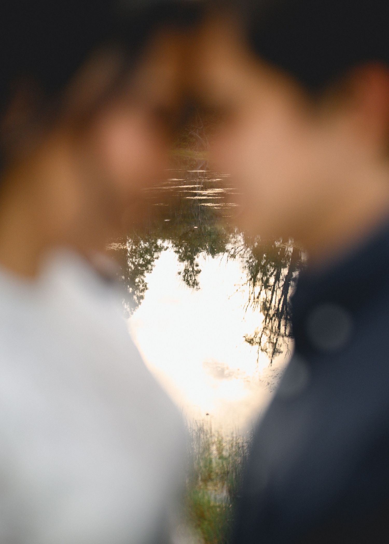 A blurred sequence of photos showing silhouettes of people against a bright sunset over water.