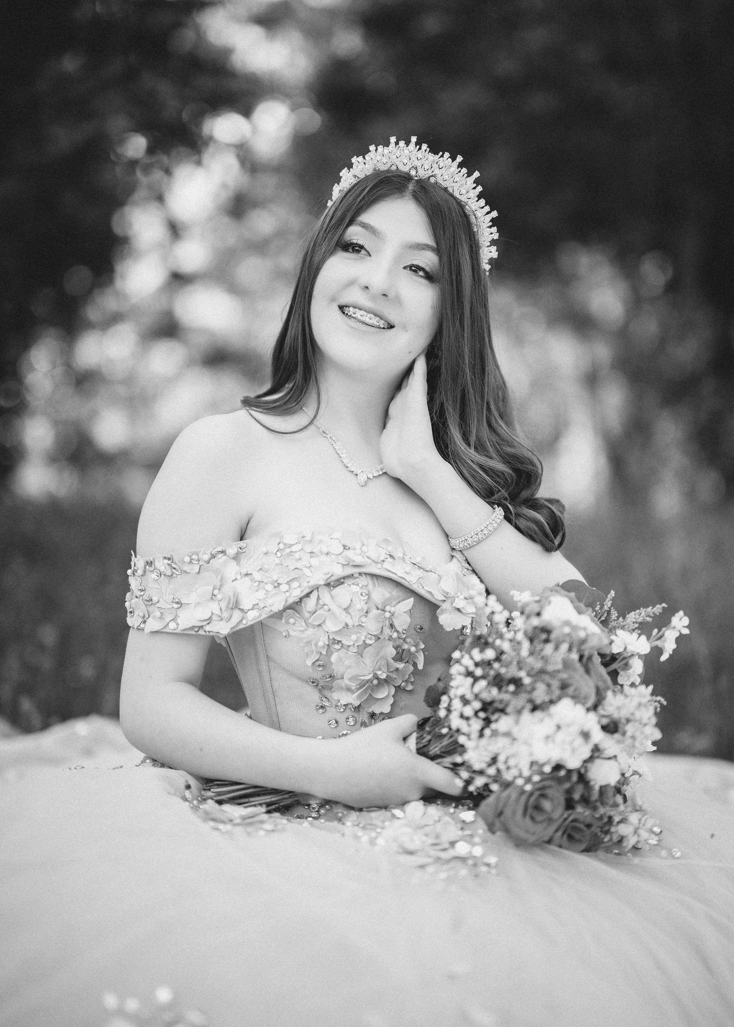 Black and white portraits of someone in an elegant white gown with lace details and floral bouquet in a dreamy outdoor setting.