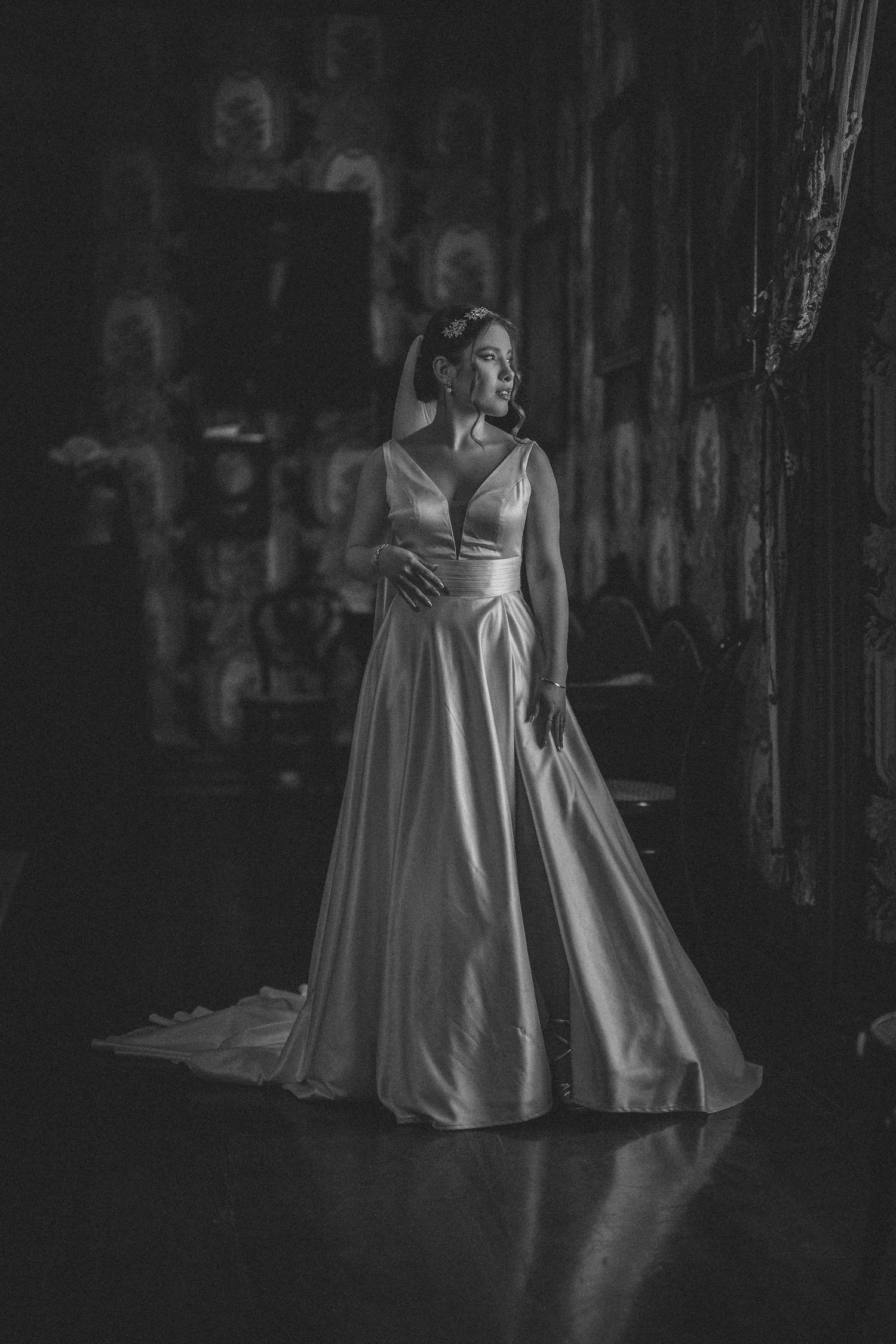 A black and white series showing the silhouette of a wedding dress in dramatic lighting.
