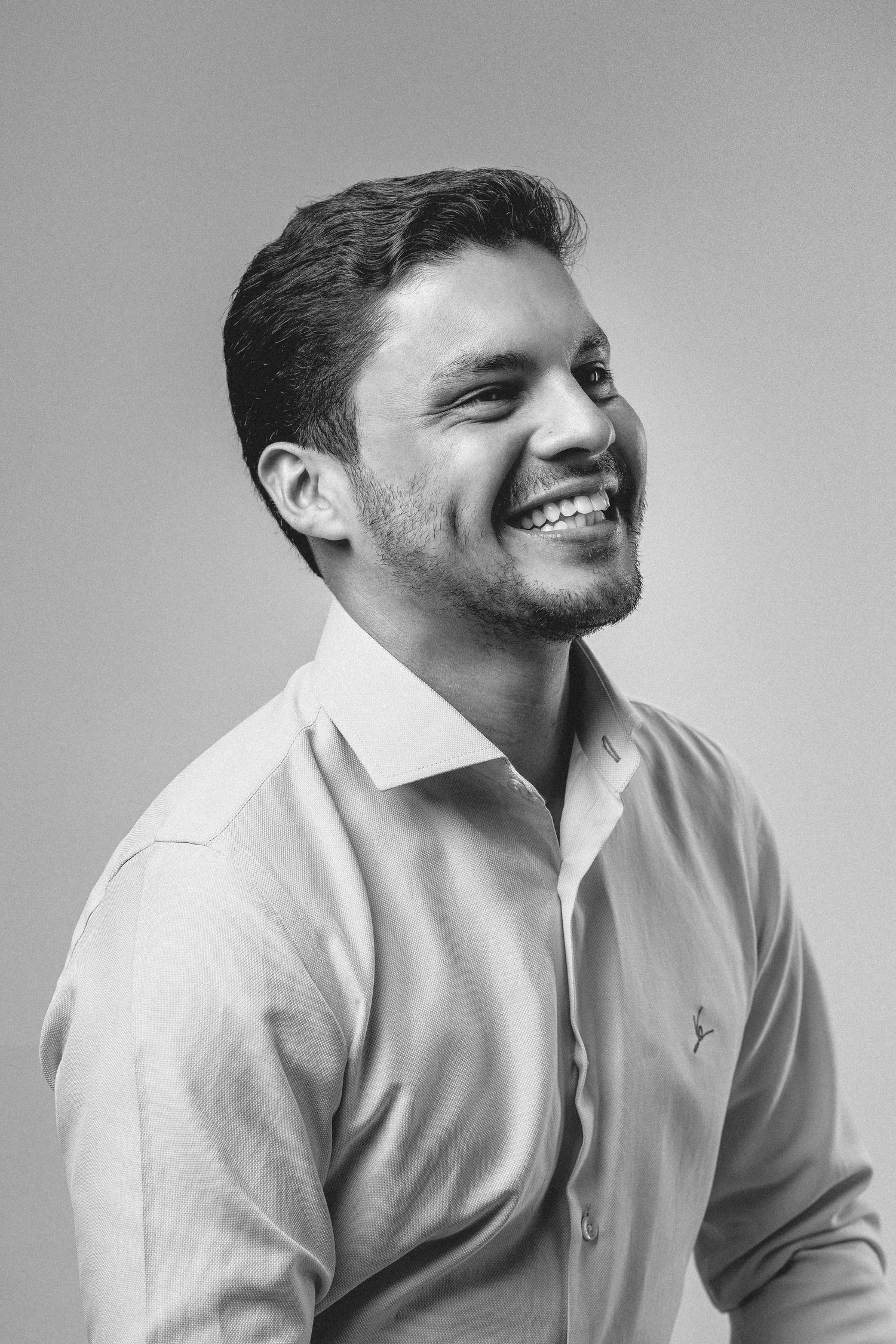 Black and white portrait series showing a person in a white shirt expressing different emotions and angles.