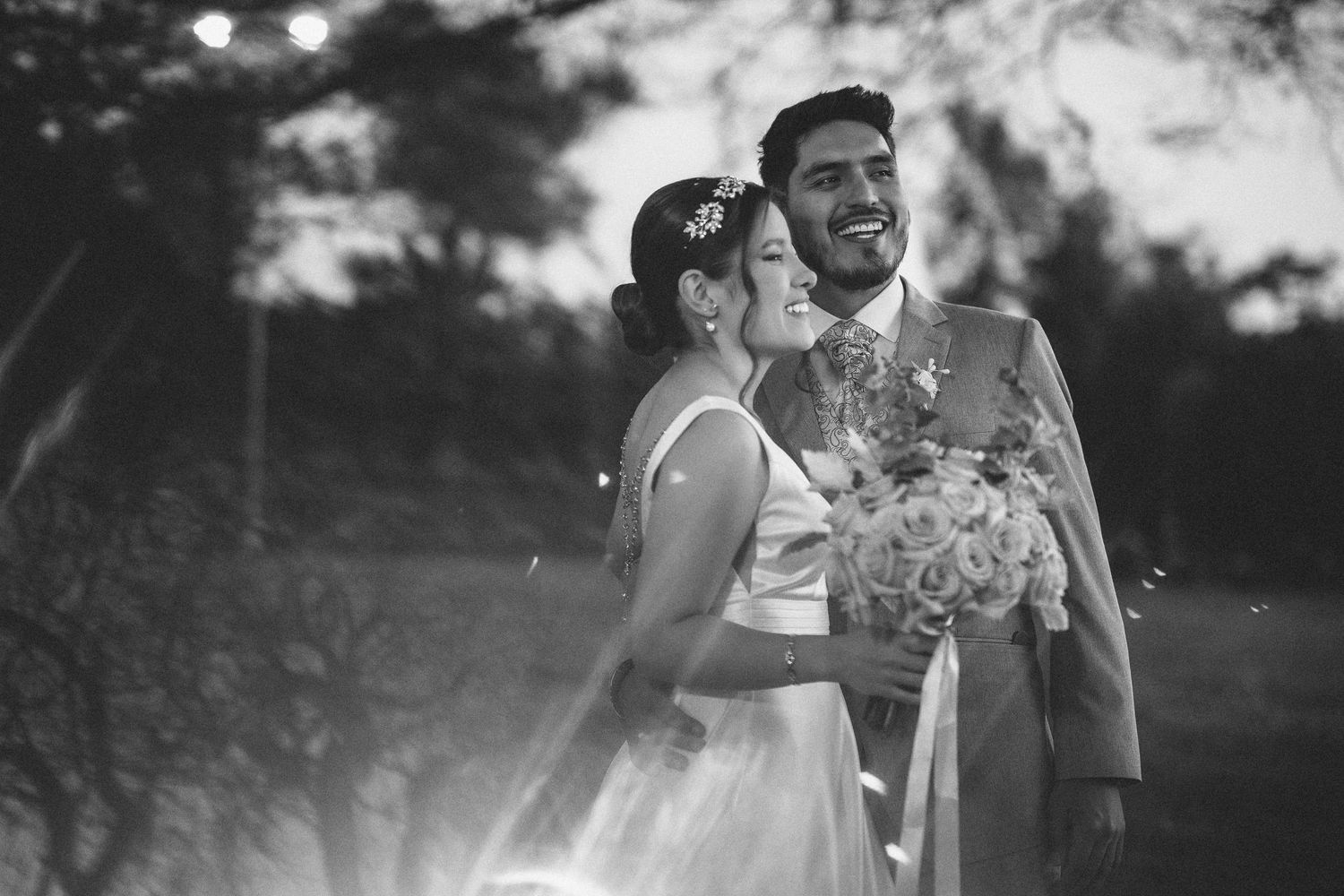 A romantic black and white wedding photo series showing intimate moments between a couple during their special day.
