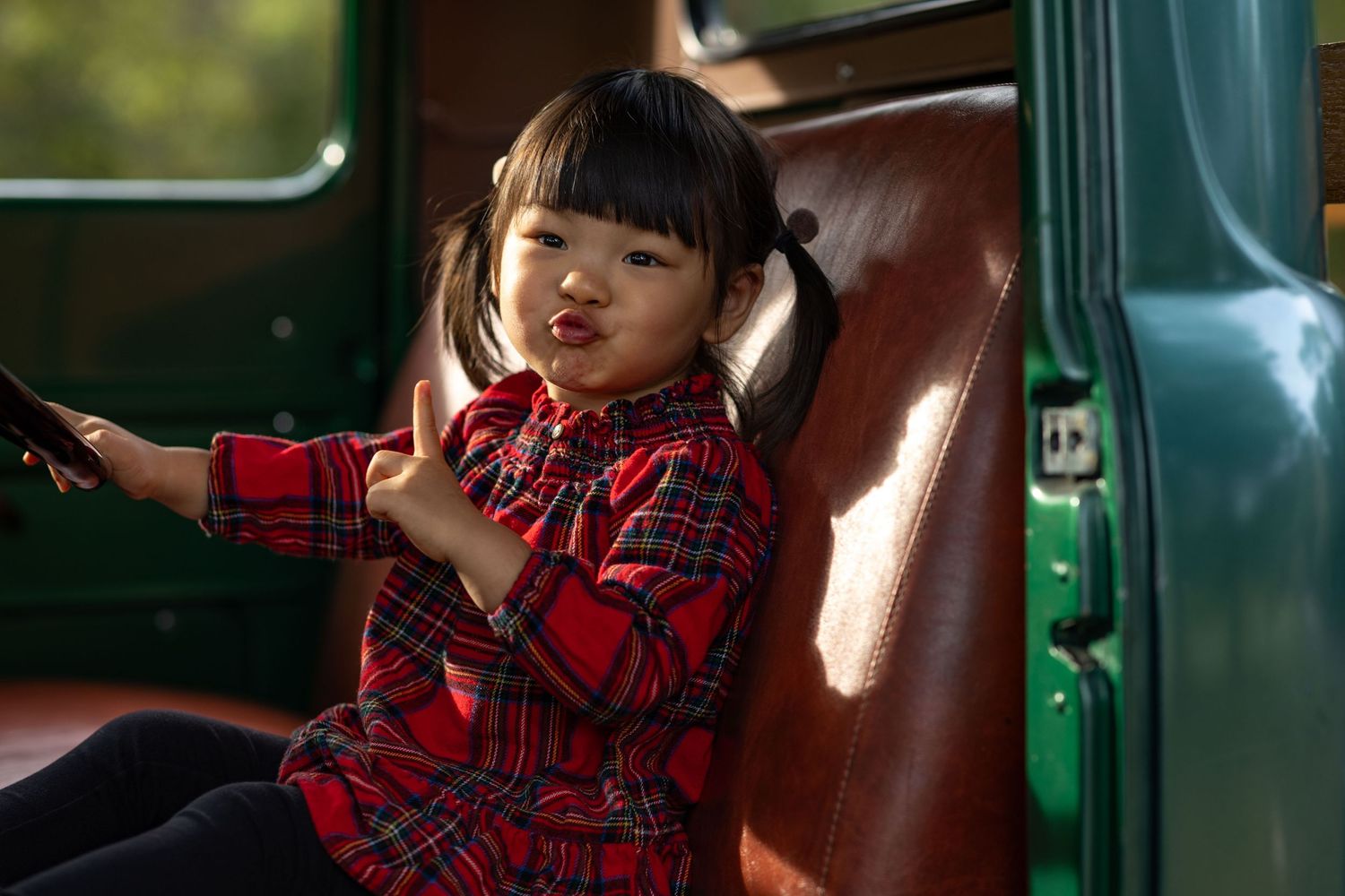 Candid moments captured in vintage car interior with natural lighting.