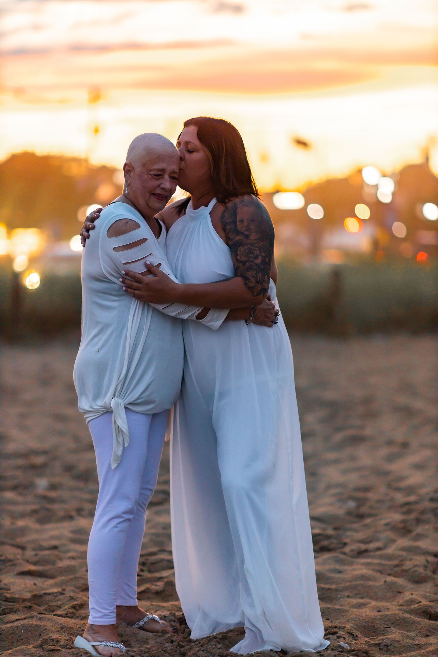 Couple sharing intimate moment on beach during golden sunset.