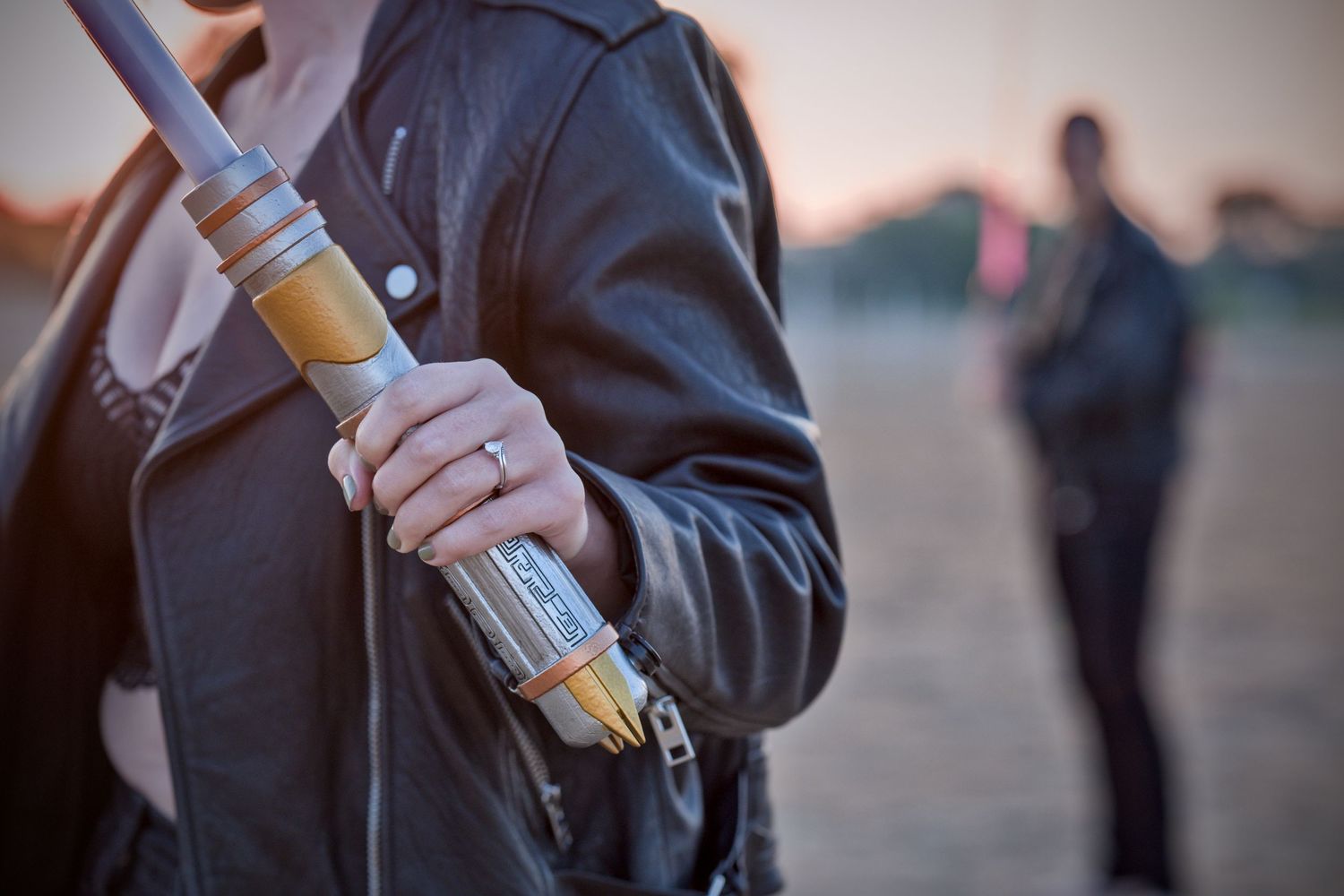 Close-up of lightsaber props being held during a Star Wars themed photoshoot.