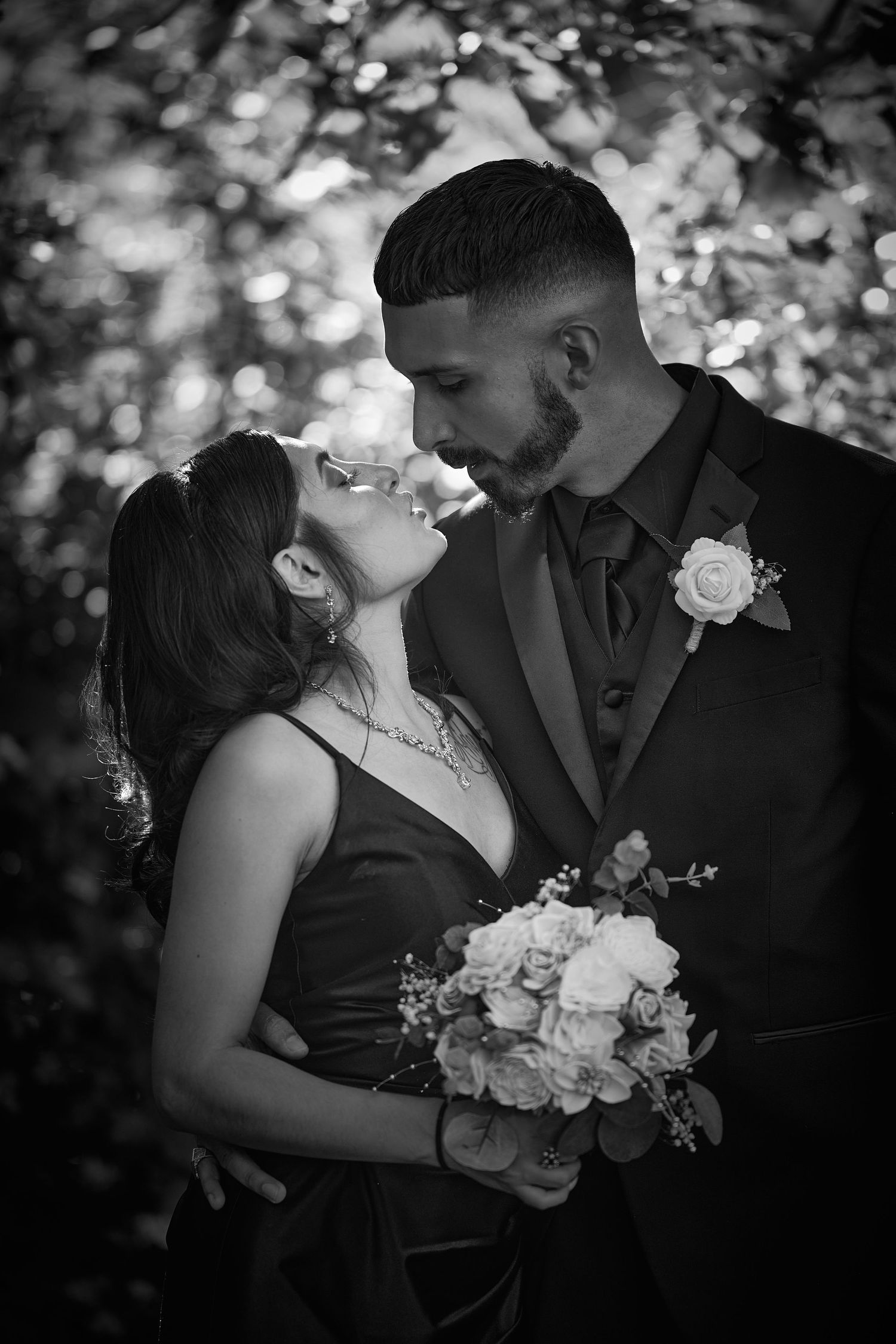 Intimate black and white wedding portraits showing tender moments between newlyweds.