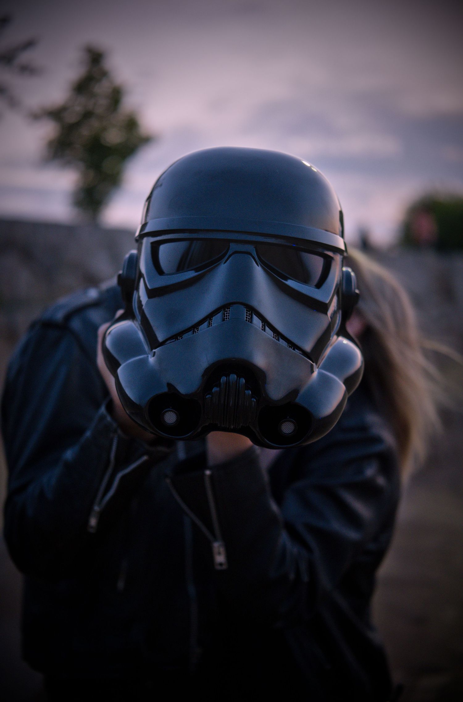 Dramatic close-up of Star Wars stormtrooper helmets in moody lighting.