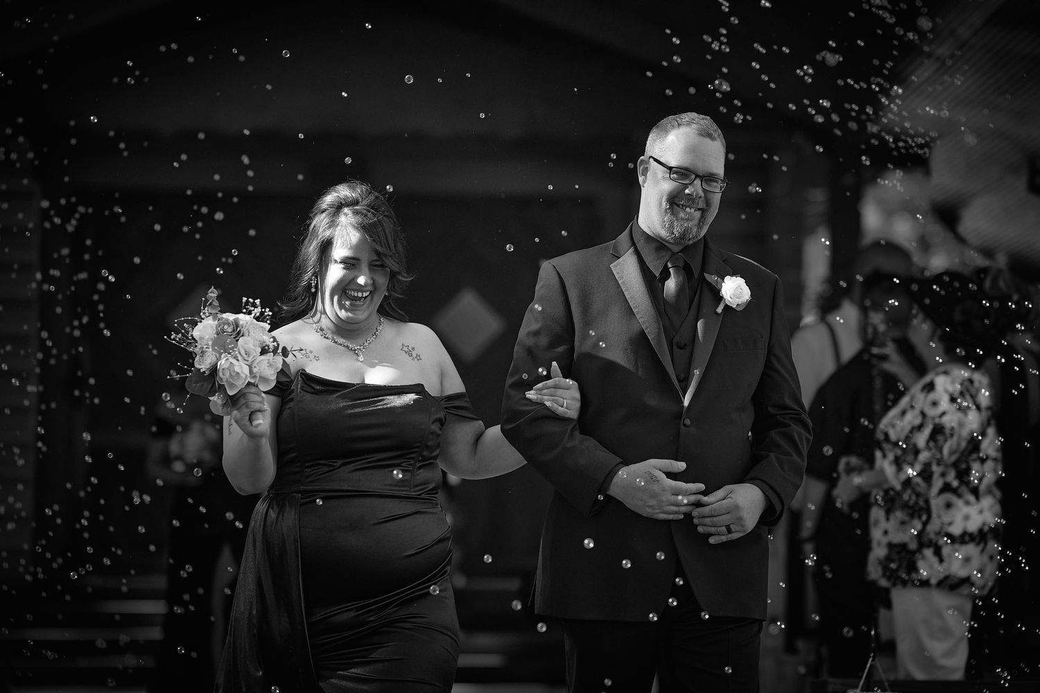 Black and white wedding celebration photos with festive sparklers creating a magical atmosphere.