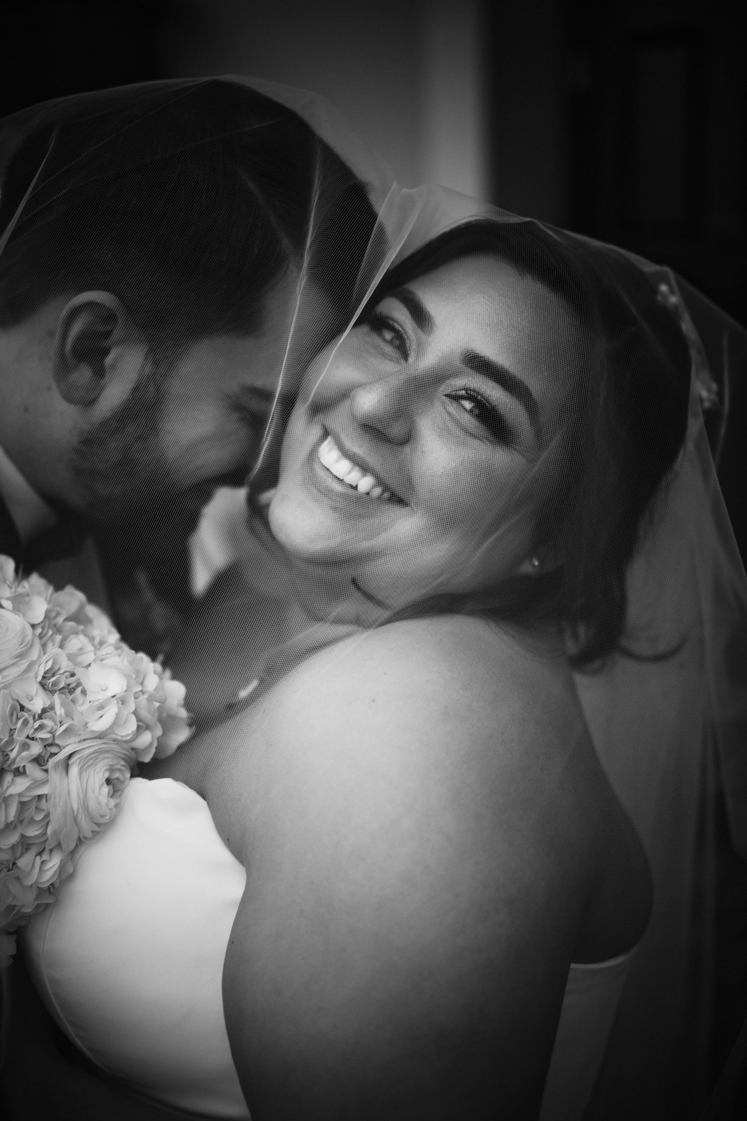 Black and white intimate wedding portrait showing tender moments between couple.