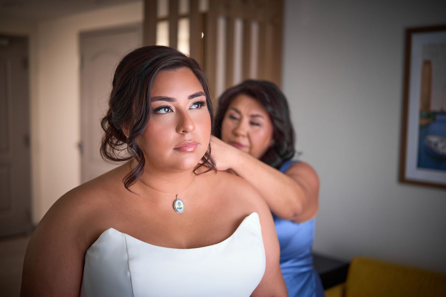 A wedding preparation scene with final touches being made to formal attire.