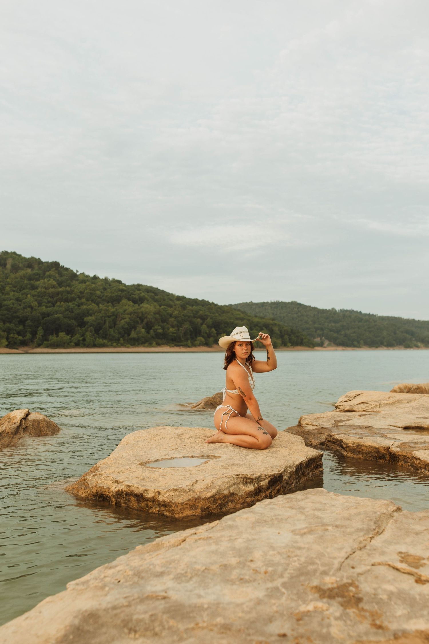 A leisurely summer moment captured on rocky outcrops overlooking calm waters.