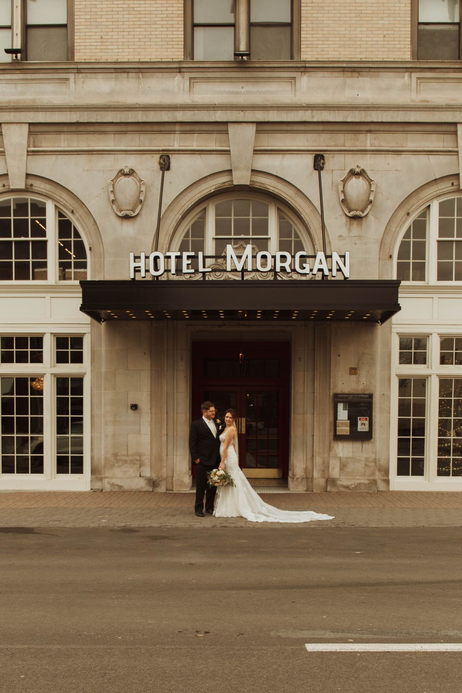 A romantic wedding portrait taken at the historic Hotel Morgan entrance.