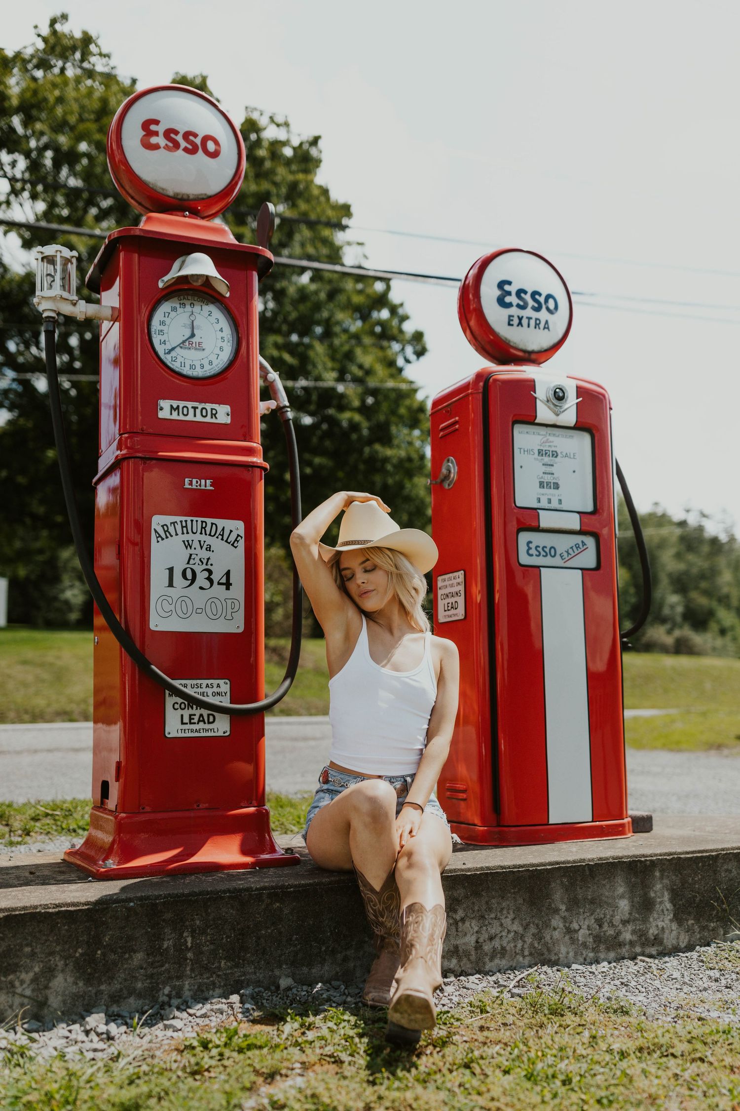 Vintage red Esso gas pumps from 1934 displayed outdoors with classic styling and period details.