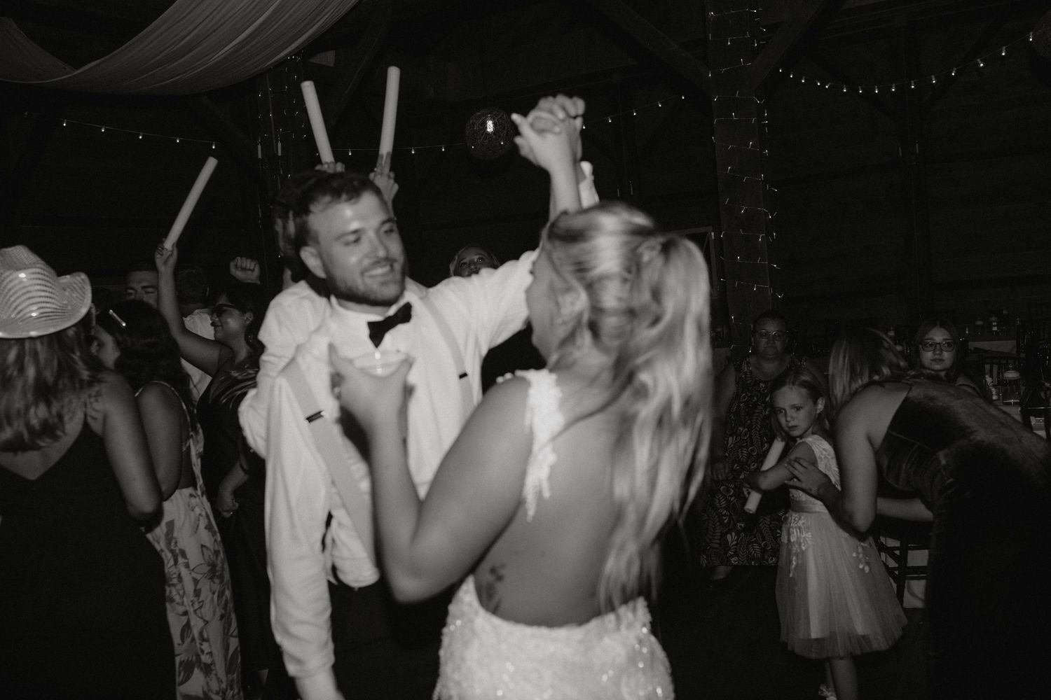 A joyous celebration on the dance floor at a wedding reception.