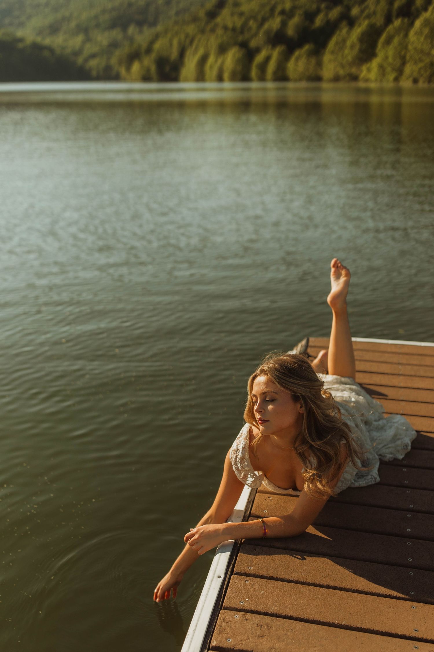 Candid moment captured on a lakeside dock during golden hour.