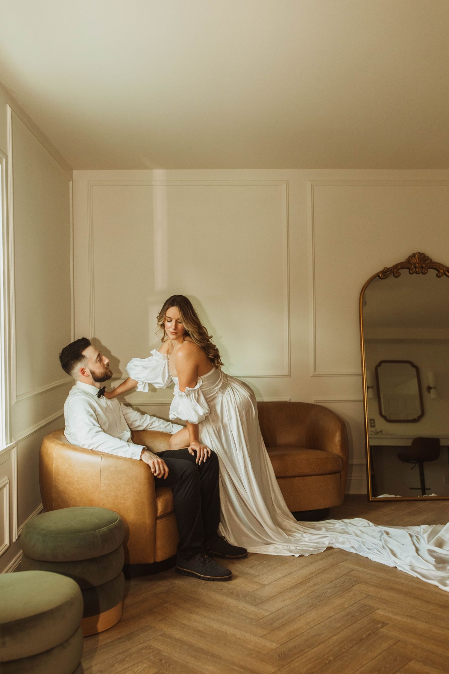 An intimate indoor wedding portrait featuring a couple in a vintage-styled room.