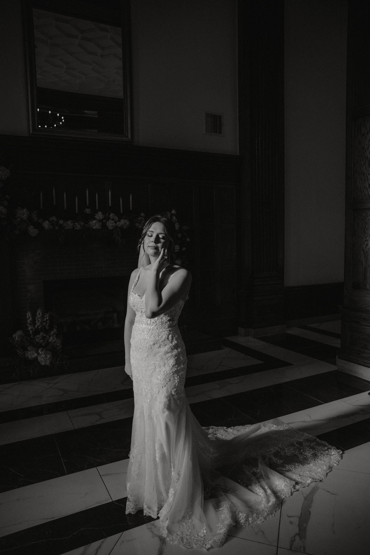 Black and white bridal portrait showing dramatic lighting and architectural details.