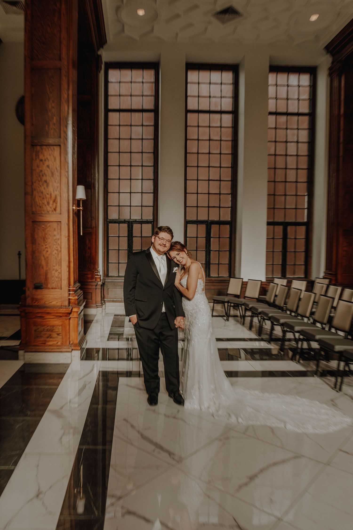 Wedding venue interior featuring marble floors and tall windows.
