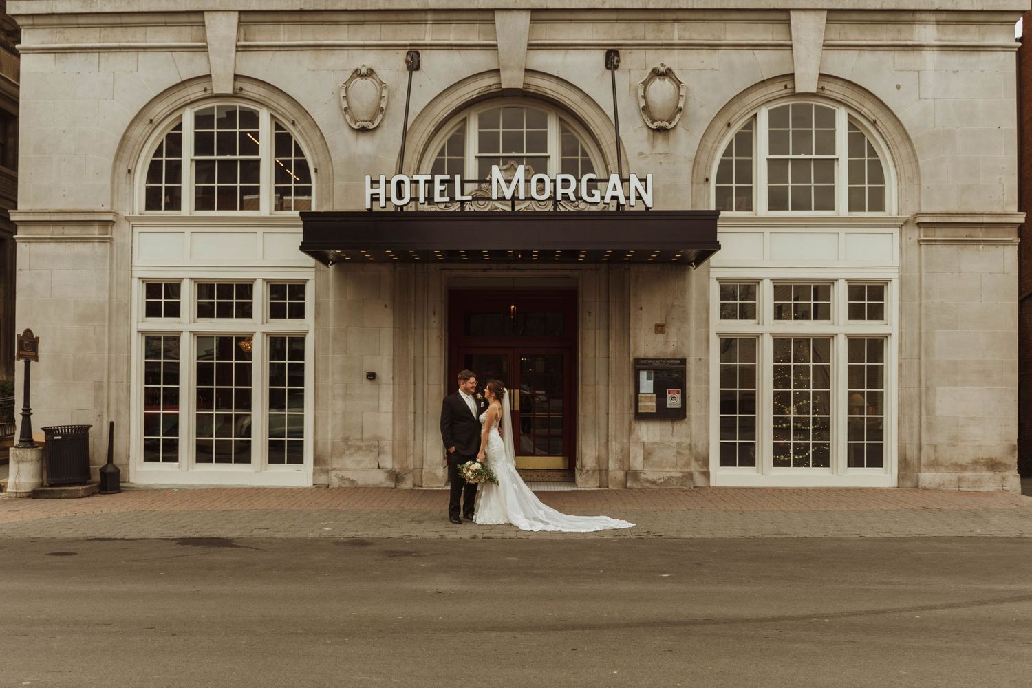 A wedding moment captured at the entrance of Hotel Morgan with its distinctive architecture.