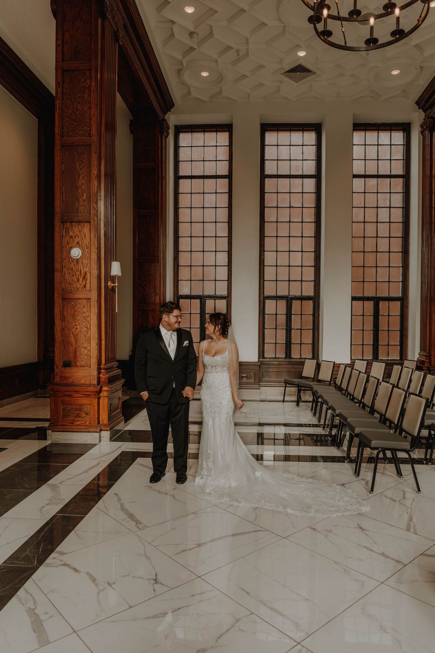 Elegant venue interior with tall windows and marble flooring.