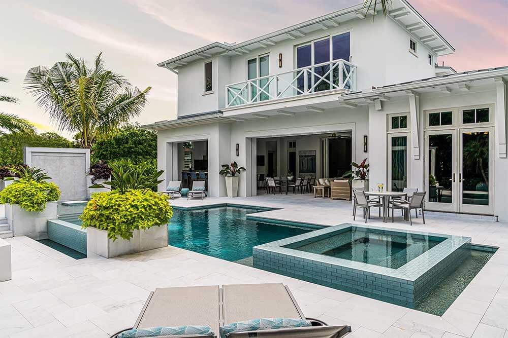 Modern luxury home with infinity pool, outdoor living space and contemporary architecture.