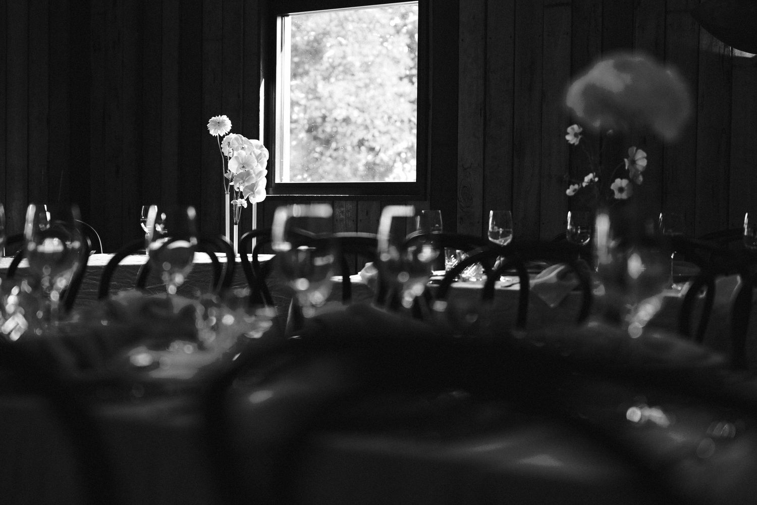 Silhouetted figures at an event with dramatic lighting and projection screen.