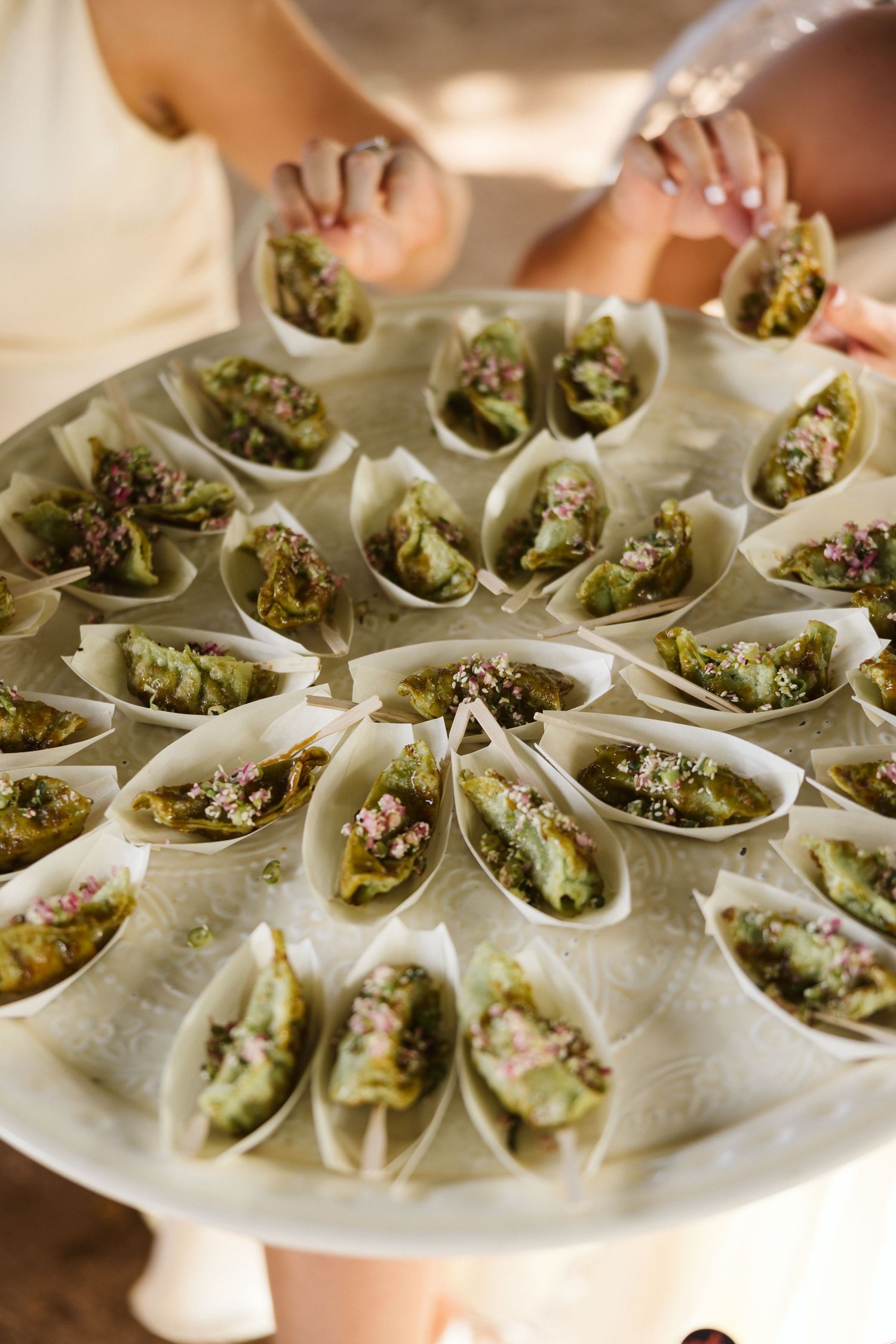 Elegant display of seafood appetizers served in individual white ceramic spoons.