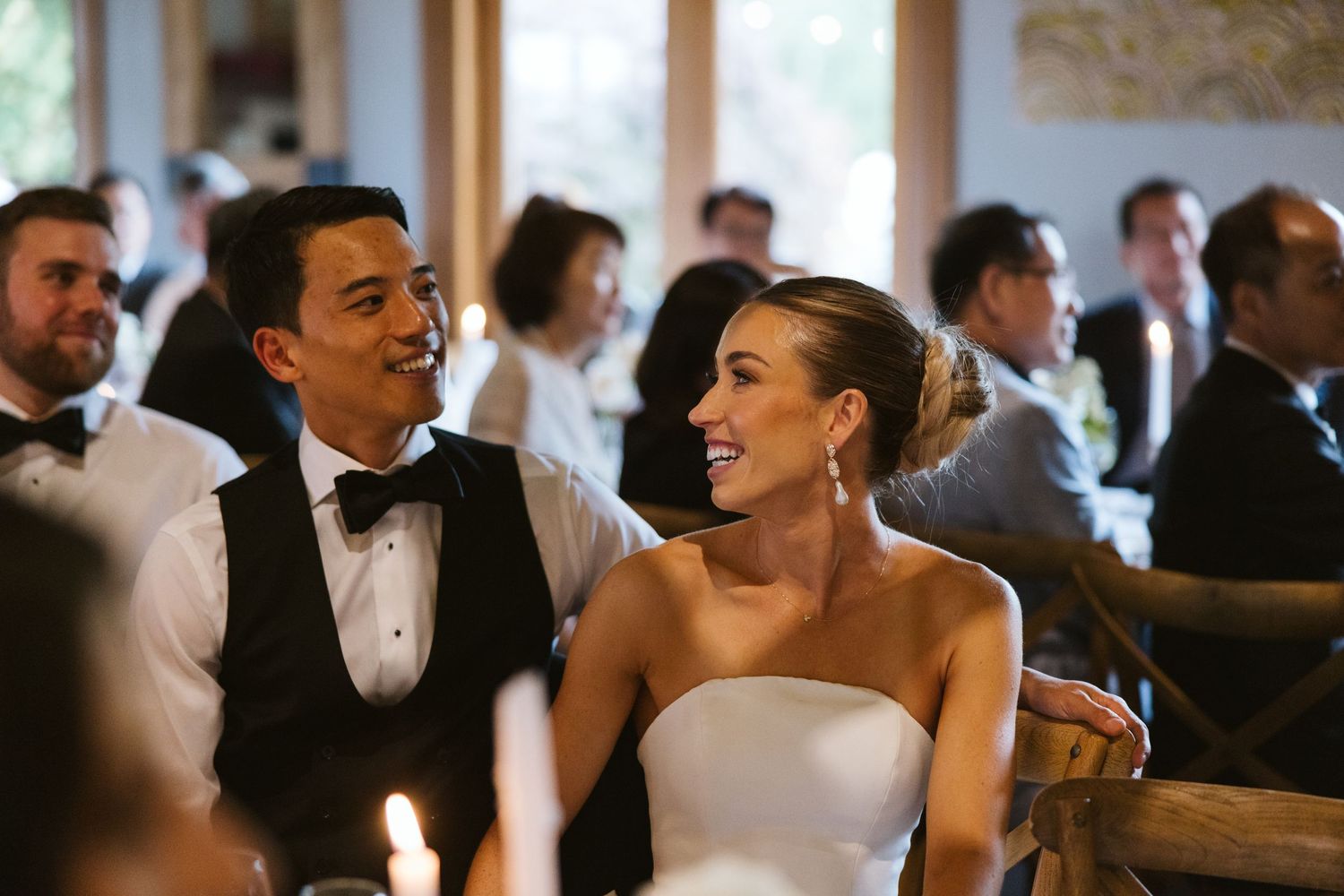 A bride and groom share a joyful moment during their wedding reception.