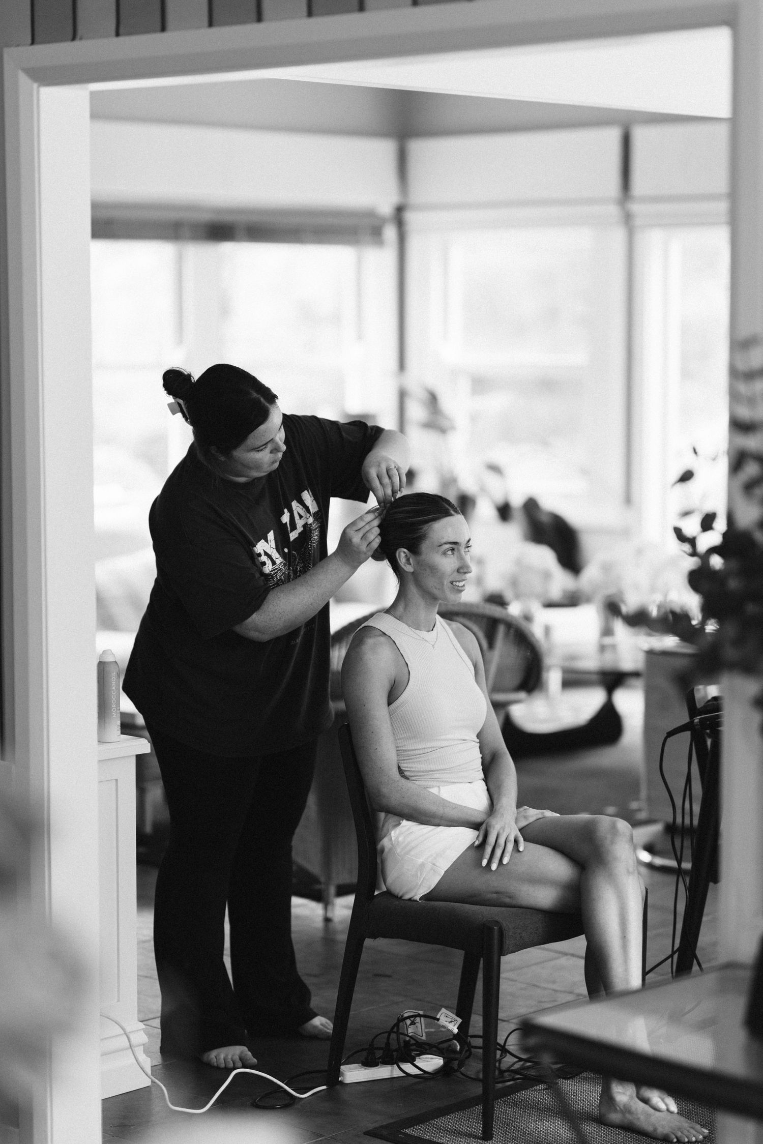 Black and white image of wedding preparation with styling in progress.