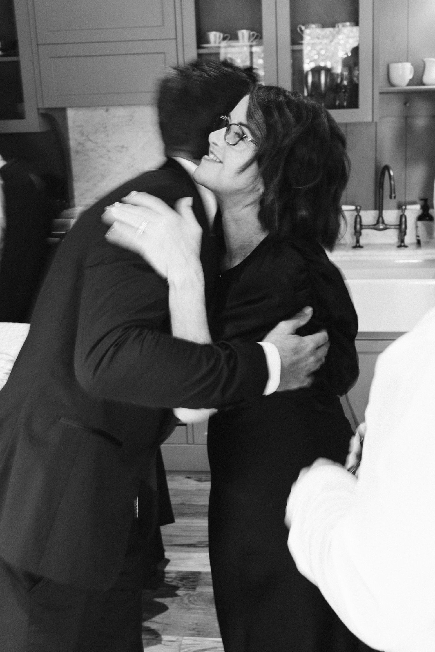 Two people sharing an emotional embrace in black and white.
