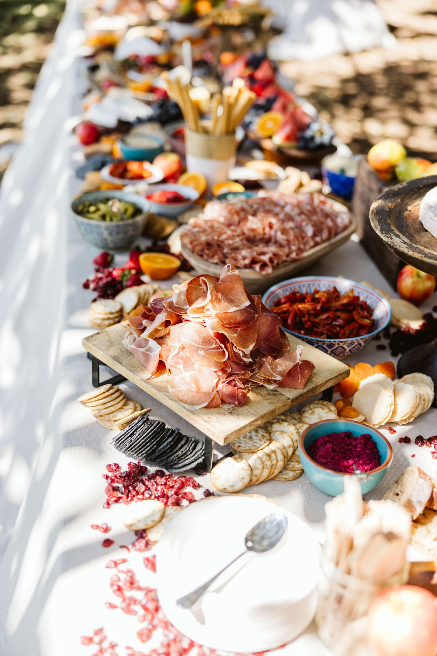 A close-up of a gourmet grazing table featuring cured meats, fruits, and artisanal cheeses.