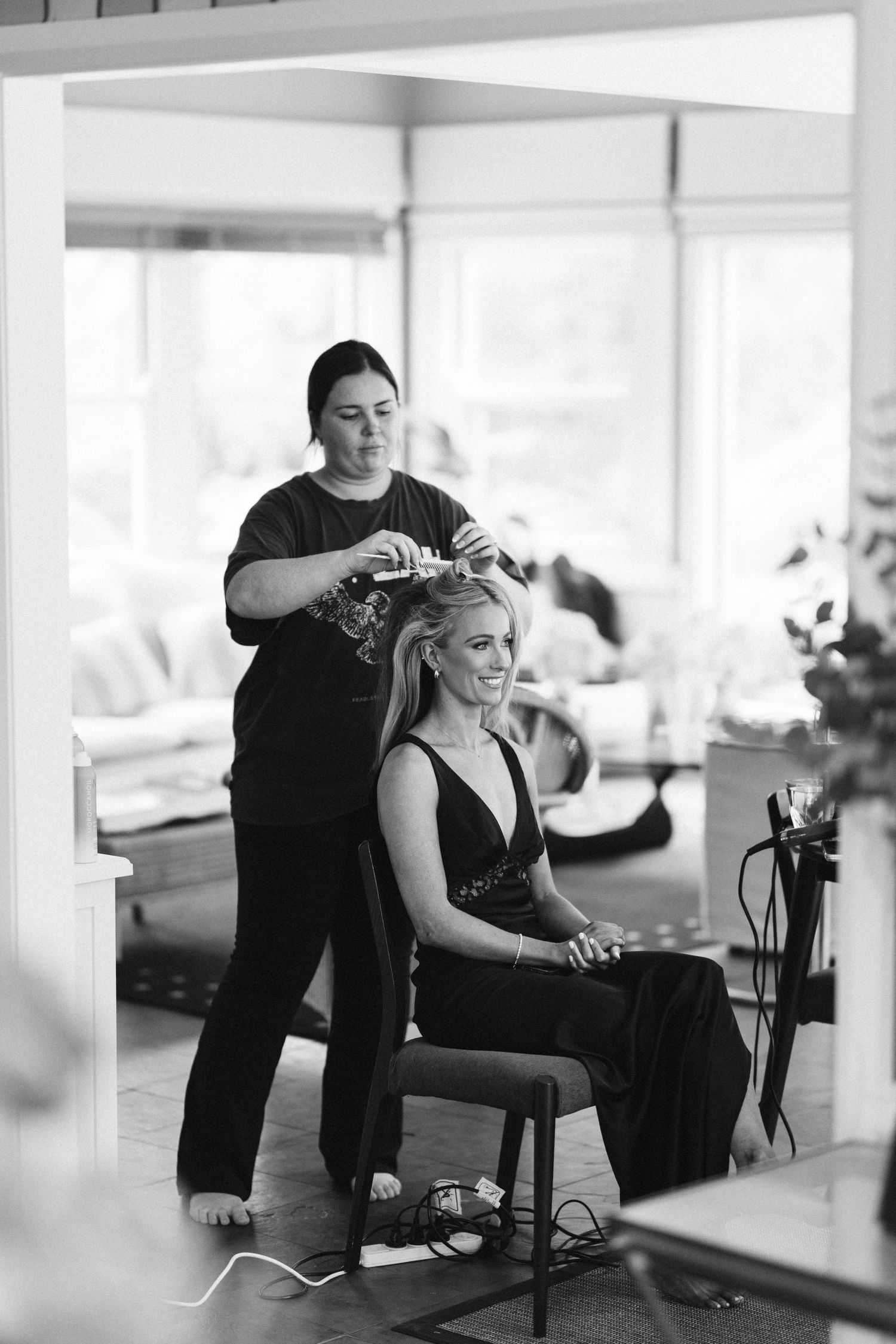 Black and white photo of wedding day hair styling session.
