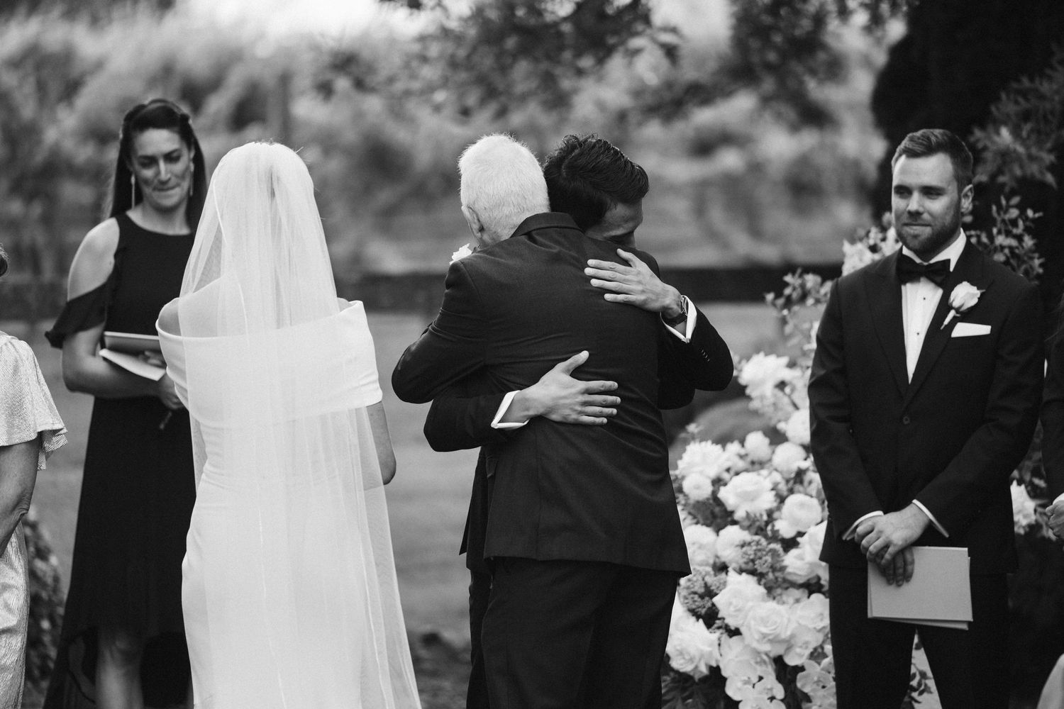 Emotional wedding ceremony moment captured in black and white photography.