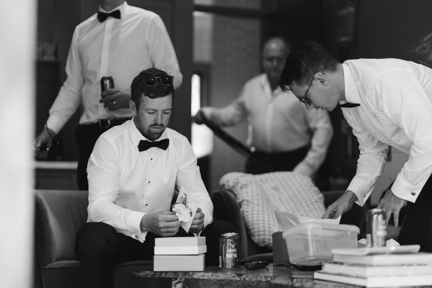 Vintage photo of staff preparing for service behind bar counter.