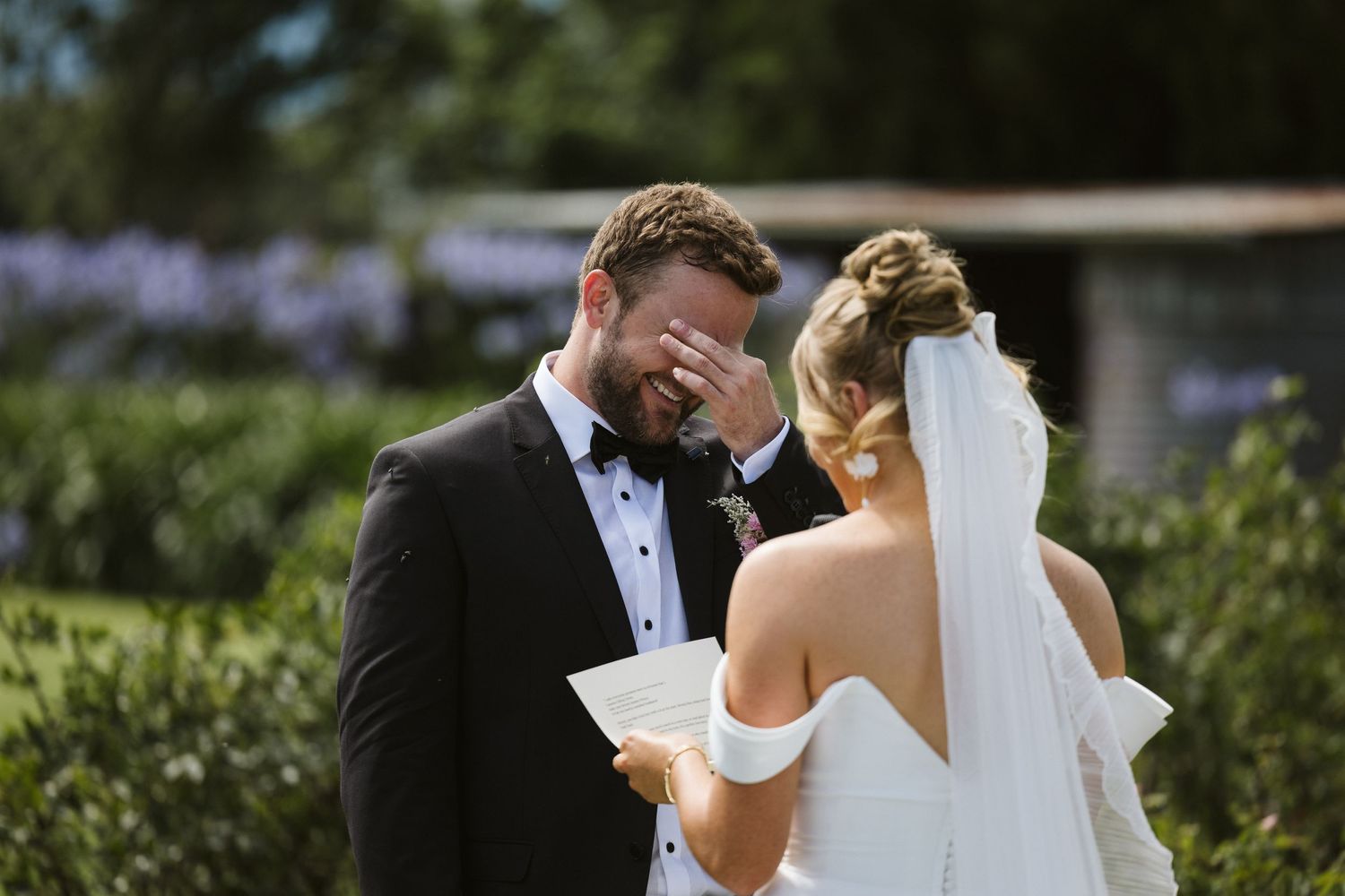 Joyful wedding moment captured in a lush garden setting.