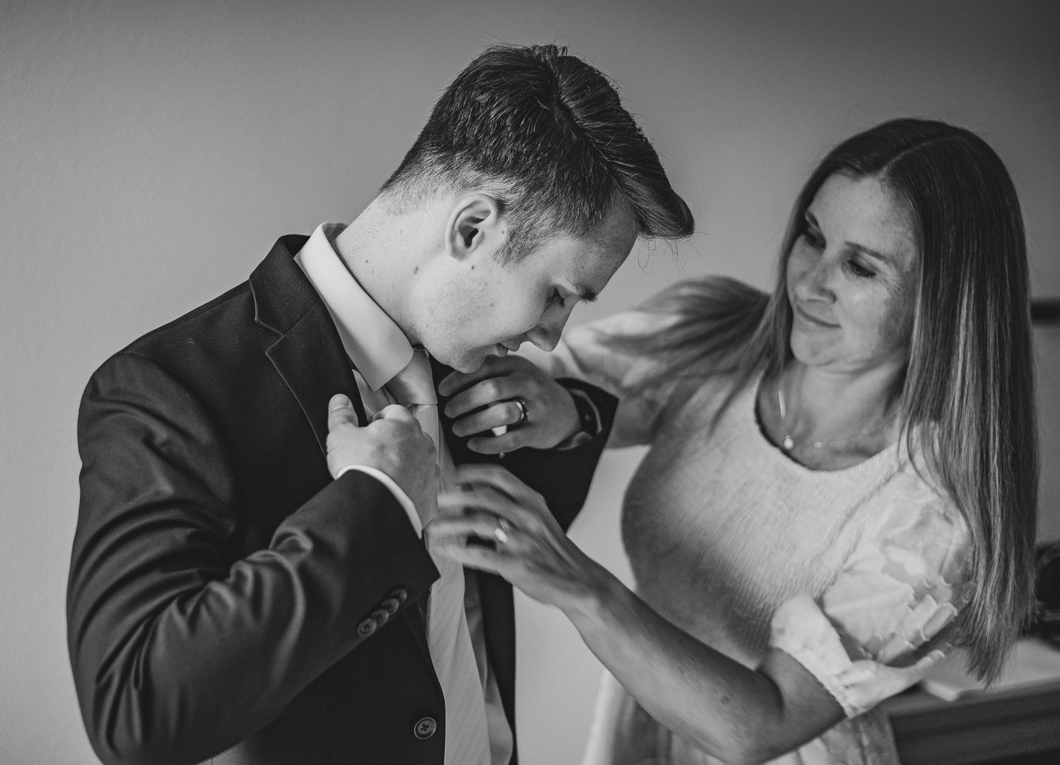 Black and white portrait series showing emotional expressions and gestures against dark background.