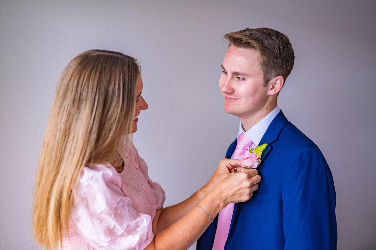 Wedding photoshoot sequence showing couple in formal attire against light background.