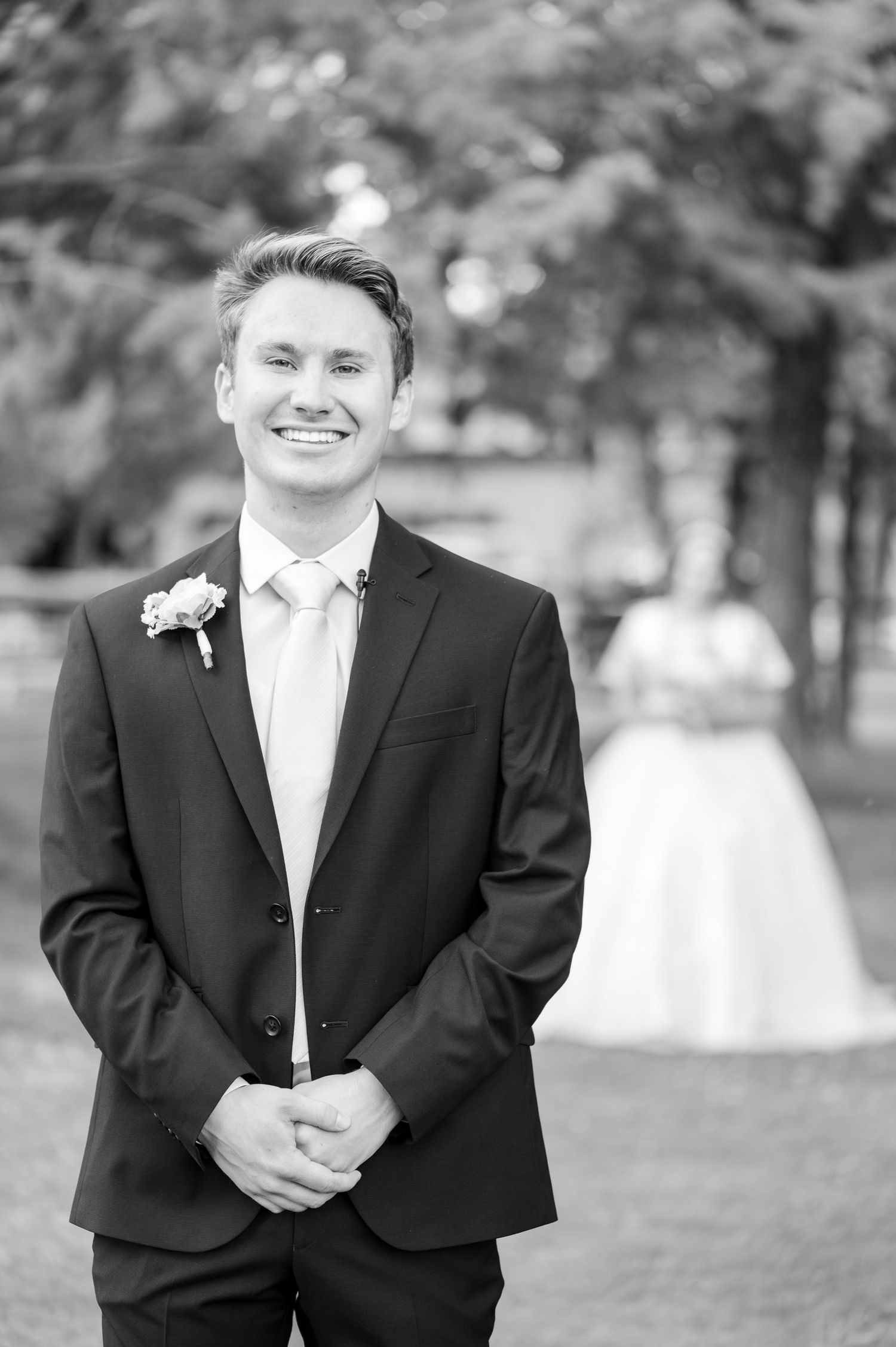 Black and white portrait series showing joyful expressions in formal wedding attire.
