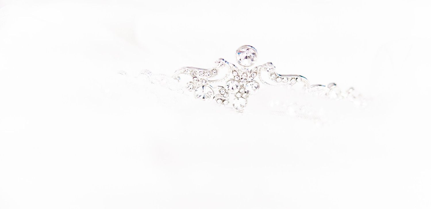 Delicate crystal and pearl bridal hair accessory on white background.