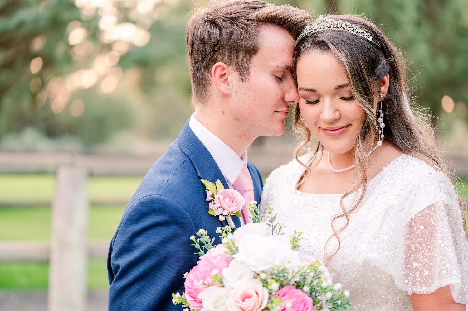 Romantic wedding portrait featuring delicate lace details and pink rose bouquet.