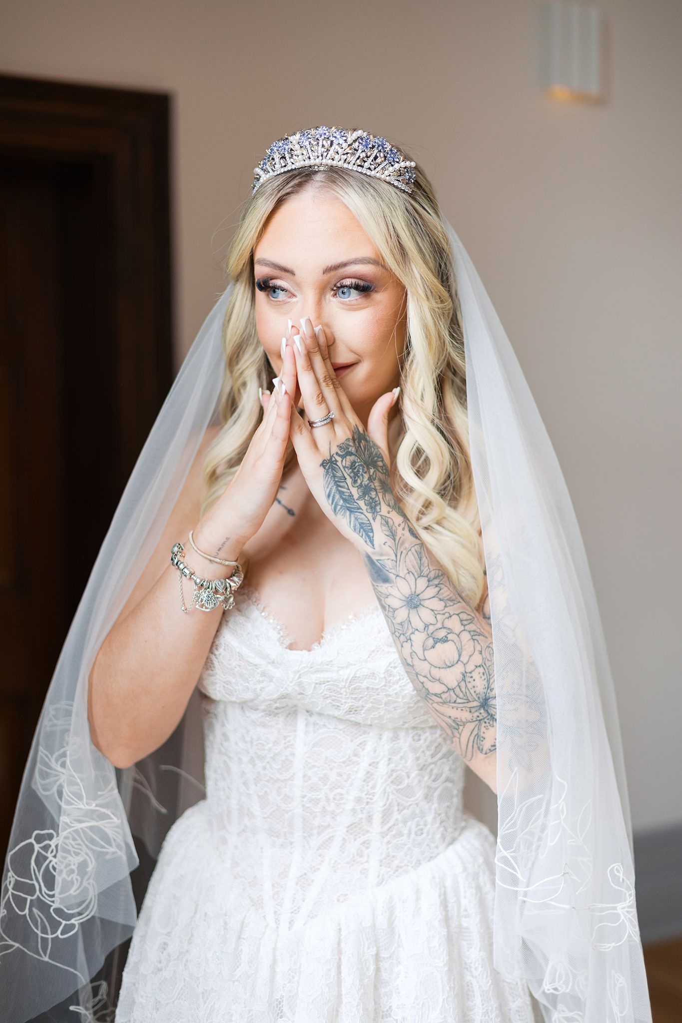 A sequence of wedding photos shows a bride in a white dress, veil and tiara expressing emotional reactions during preparation.