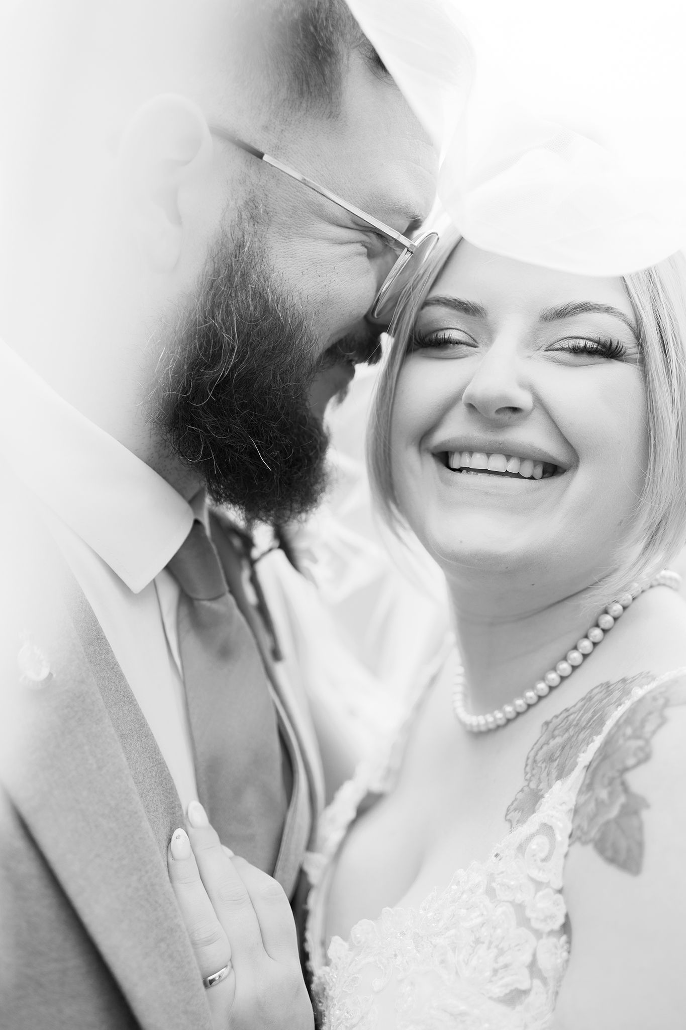A romantic black and white wedding photo collage showing close-up intimate moments between newlyweds.