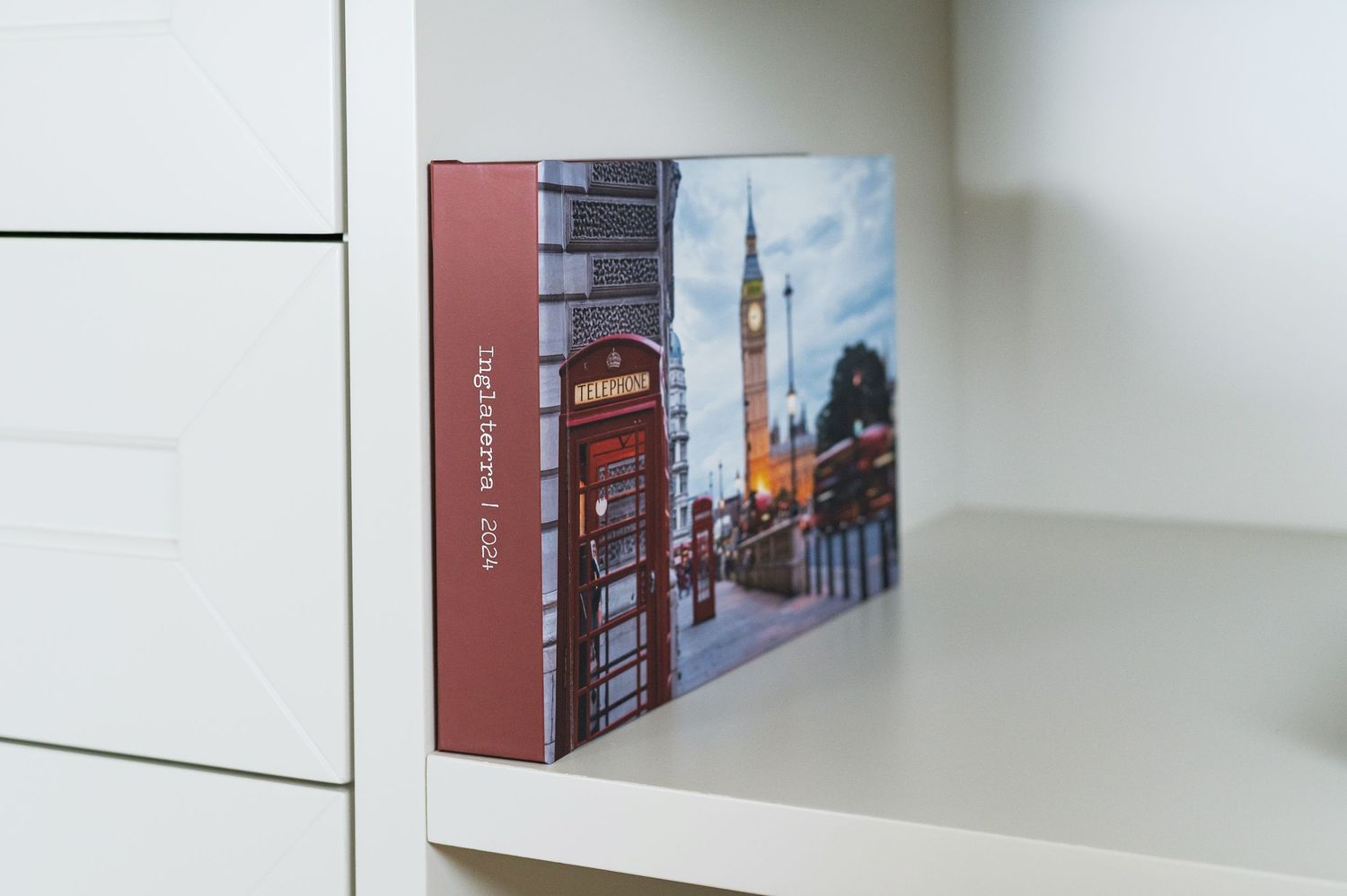 A series of framed photographs showing urban scenes and architecture displayed on a white wall.