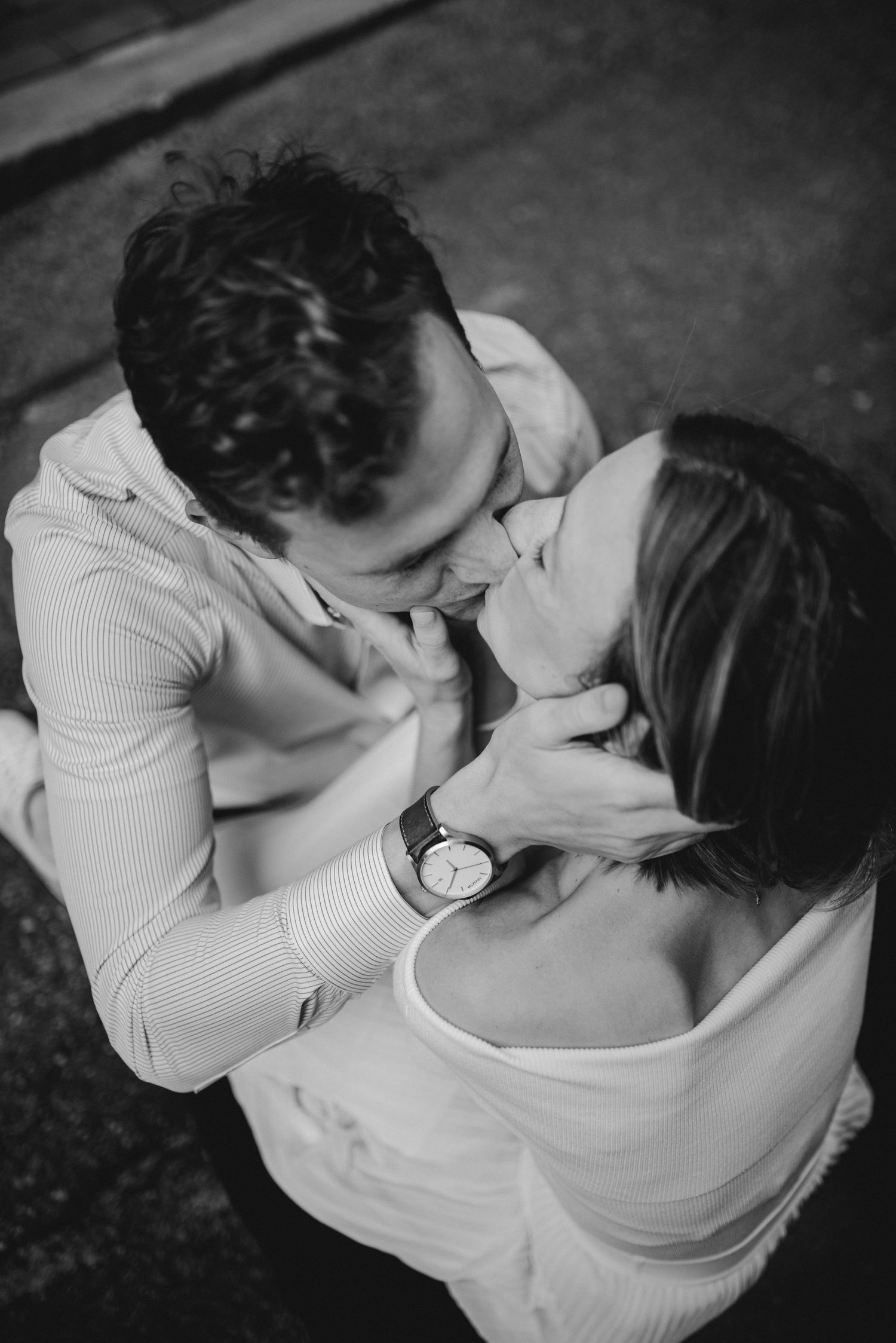 Intimate black and white portrait of a romantic couple sharing a tender moment.